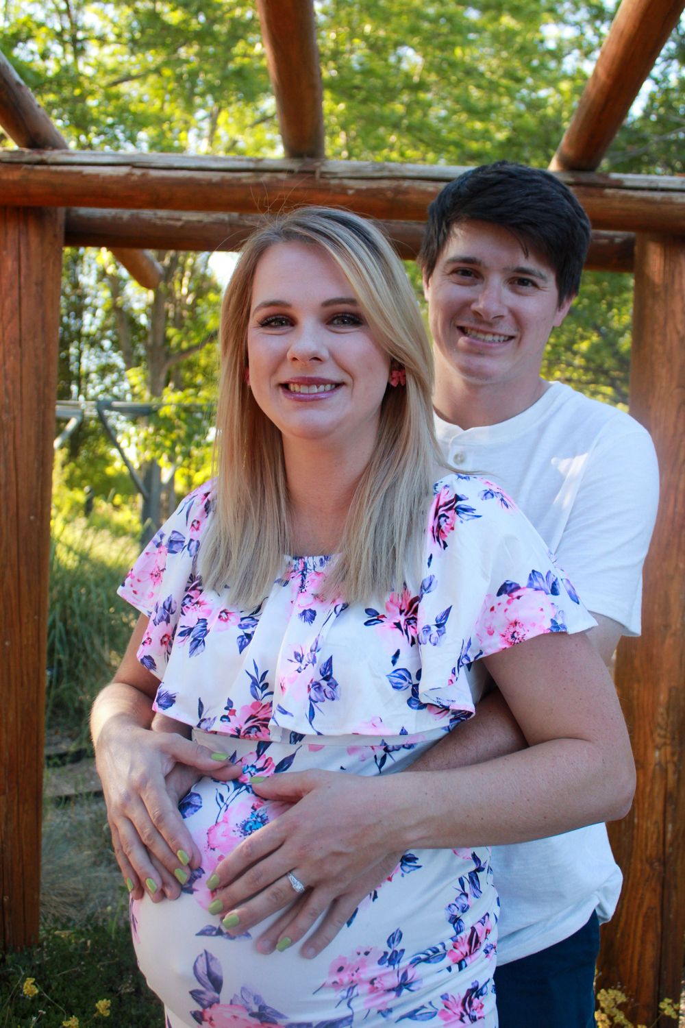 A couple shares tender moments in a series of photos on a wooden deck with lush greenery in the background.