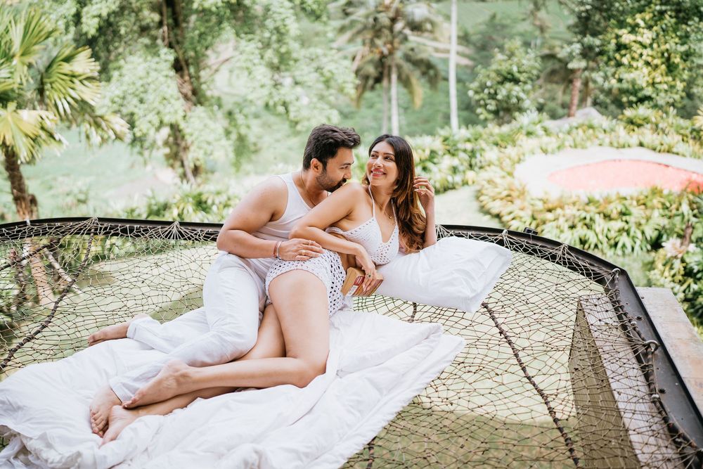A romantic scene on a white blanket laid out on an outdoor trampoline.