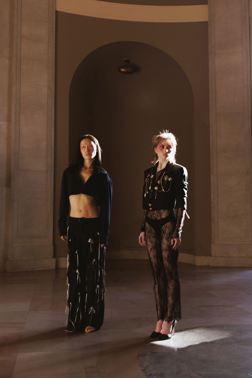 Sequential composite image showing people in black attire walking through an arched stone hallway.