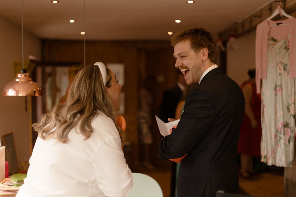 Guests dance and celebrate together on a warm-lit dance floor during a wedding reception.