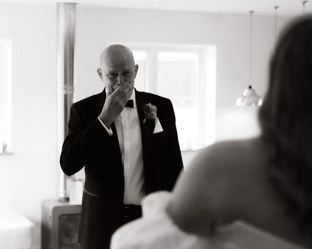 A series of five black and white photos showing tender moments during a wedding ceremony.