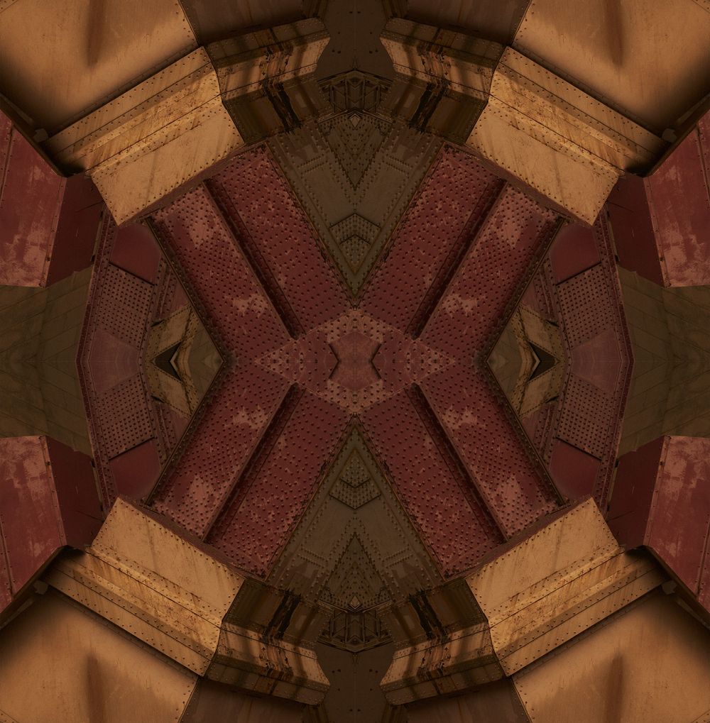 Kaleidoscopic pattern in warm brown and burgundy tones creates a symmetrical architectural design.