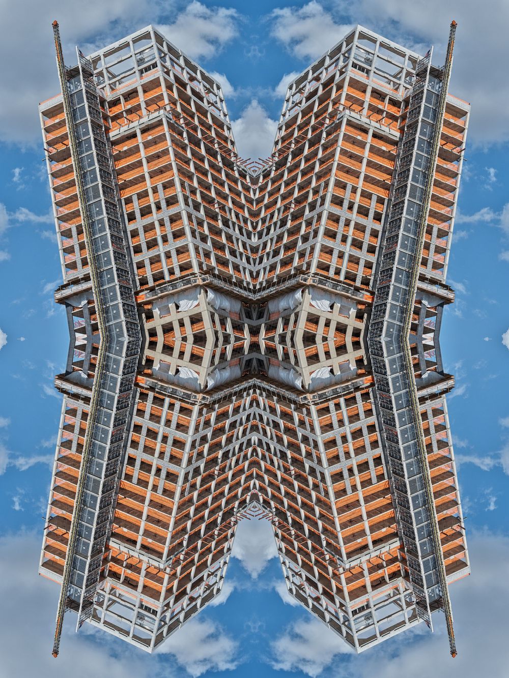 Abstract kaleidoscope pattern created from architectural elements of a modern building against a blue sky.