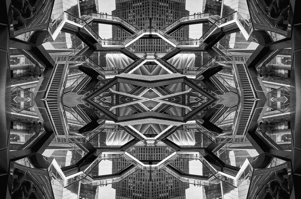 Abstract black and white kaleidoscope pattern created from architectural elements forming a symmetrical geometric design.