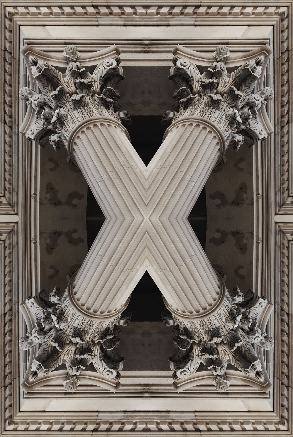 Ornate baroque ceiling details with repeating X patterns in white and gray architectural moldings.