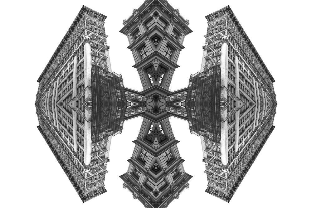 Abstract kaleidoscopic pattern created from architectural elements forming a symmetrical black and white design.