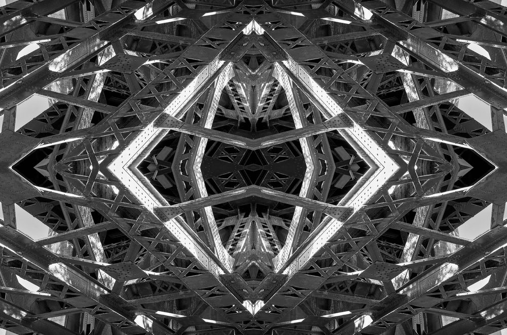 Abstract black and white kaleidoscope pattern with geometric shapes and symmetrical designs creates a mesmerizing visual effect.