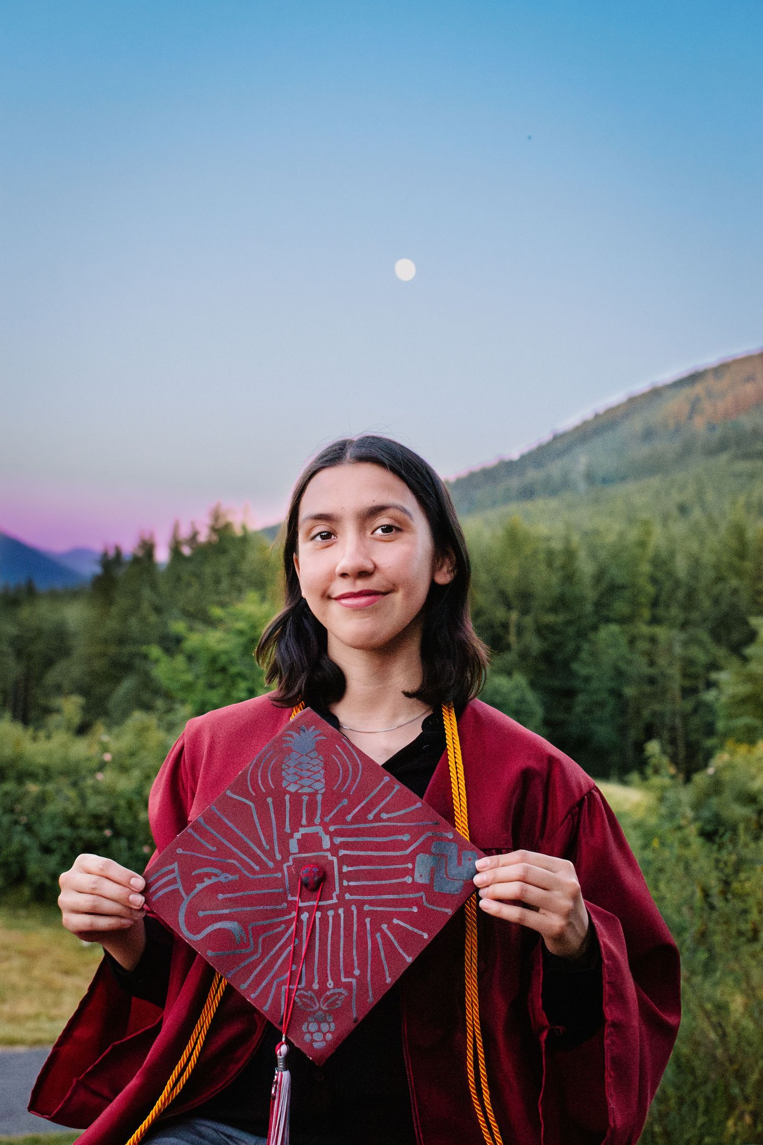 Close-up of decorated graduation cap with cybersecurity theme. Snoqualmie point park. Golden hour graduation photography Seattle.