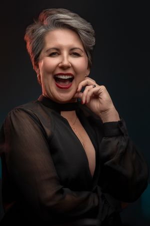 Portrait series showing joyful expressions and laughter against dark background with dramatic lighting.