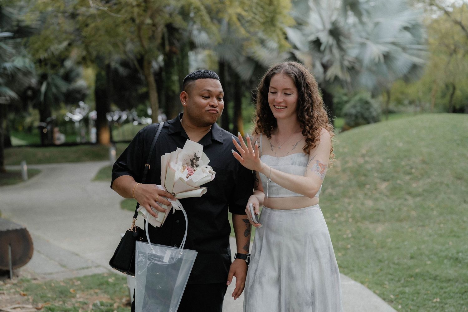 Sweet interactions captured in a tropical garden setting with natural lighting.