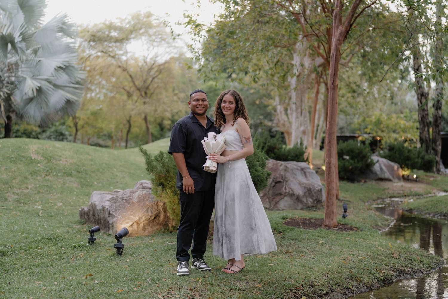 A romantic garden wedding photoshoot with natural landscapes and greenery in the background.