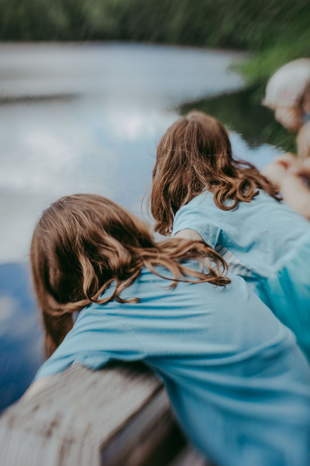 A series of images showing someone's brown hair flowing in the wind while wearing a light blue shirt outdoors. Whitney Popp, Arizona.
