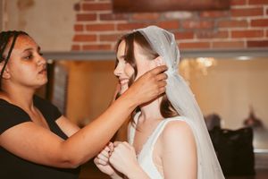 Series of photos showing dress adjustments and finishing touches during a wedding preparation.