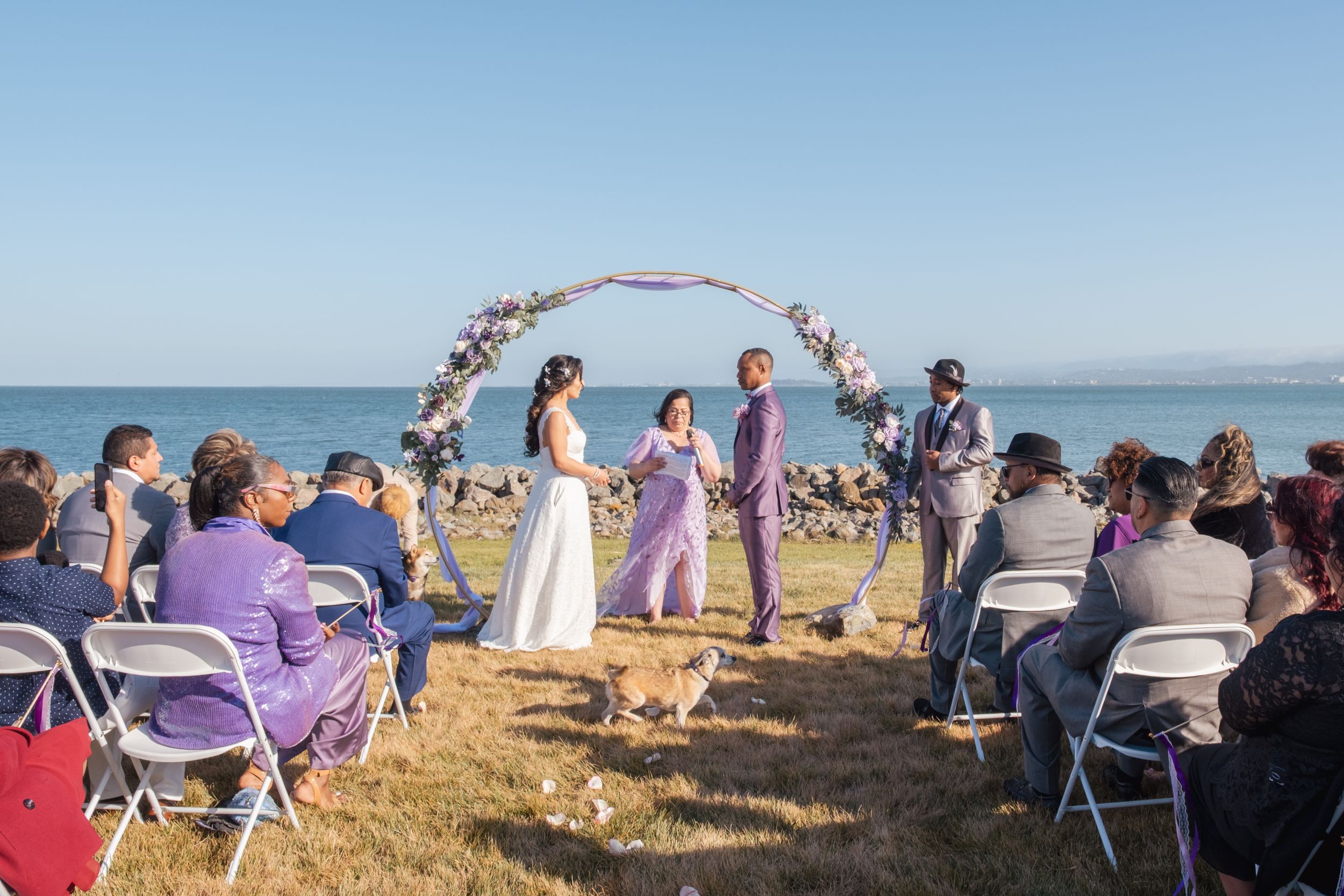 Couple getting married during a lilac themed wedding.