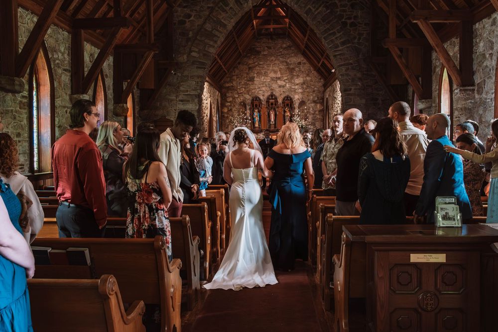Bride walking down aisle to groom at Cragsmoor stone church wedding ceremony in Hudson Valley NY