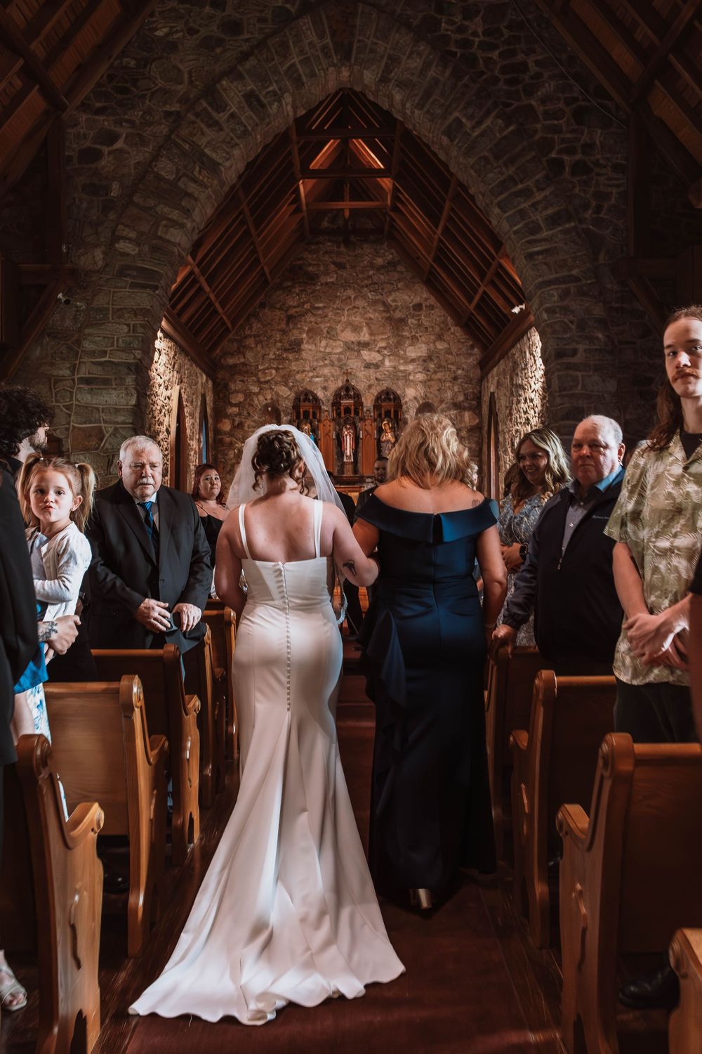 Bride walking down aisle at Cragsmoor stone church wedding ceremony in Hudson Valley NY