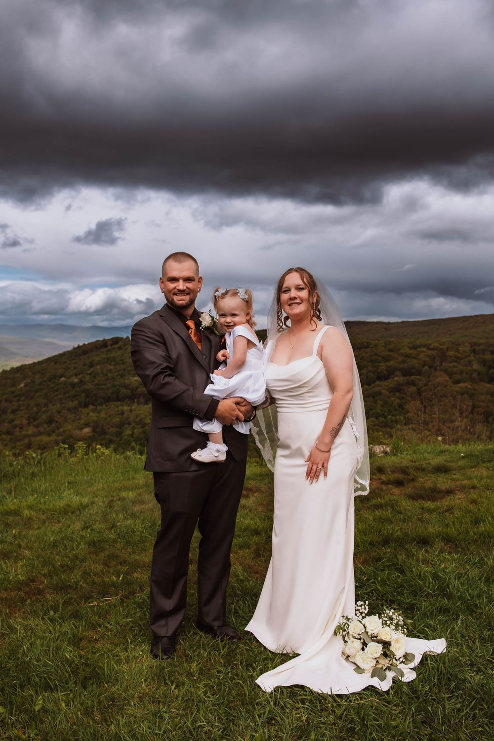 Bride Groom and daughter with mountain views at cragsmoor stone church hudson valley NY