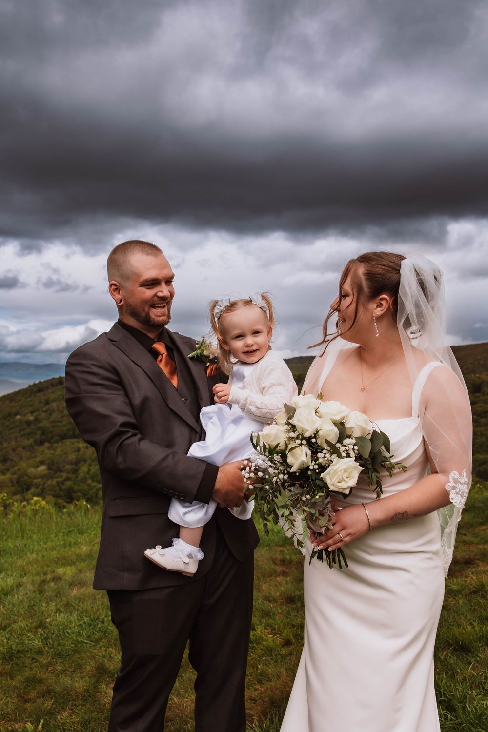 candid of Bride Groom and daughter with mountain views at cragsmoor stone church hudson valley NY
