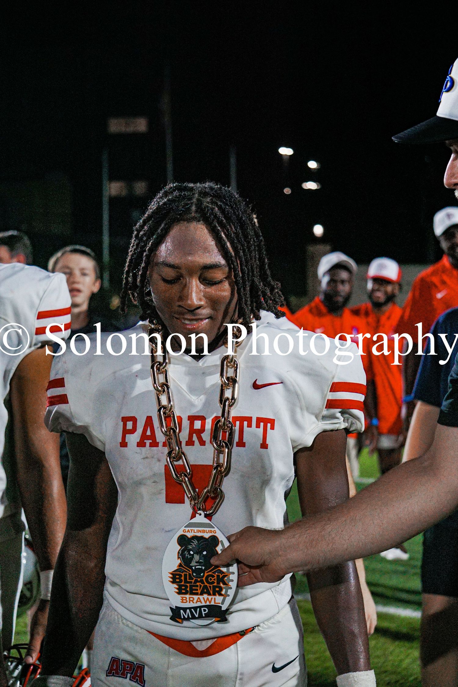 Parrott football player receives MVP chain award after game, photographed by Solomon Photography.