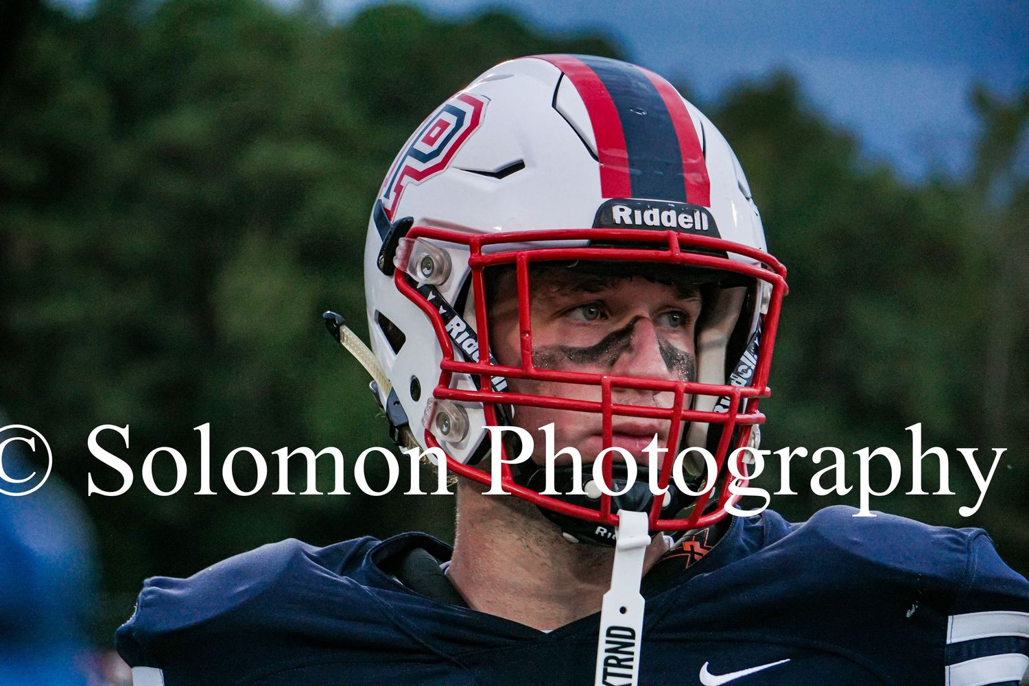 Close-up of a Parrott Academy football player wearing a Riddell helmet looking focused during a game.