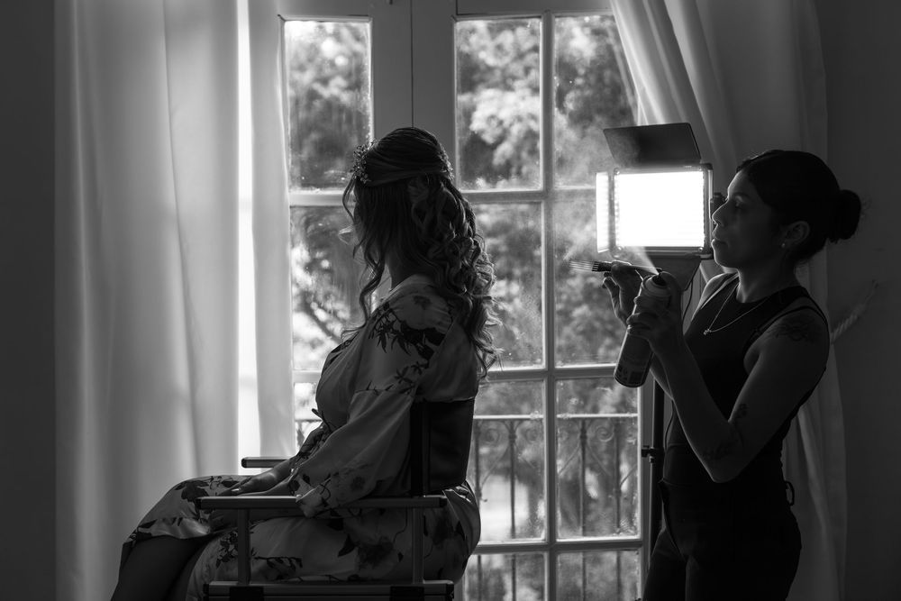 Healthcare workers in silhouette consult near hospital windows during a medical shift.