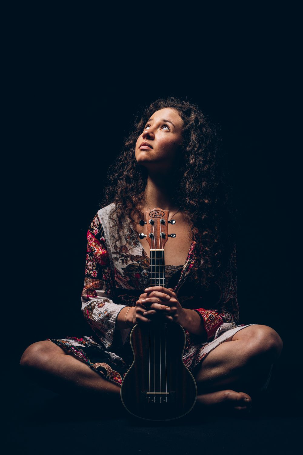 Atmospheric portrait series featuring a musician with curly hair holding a violin in moody lighting.