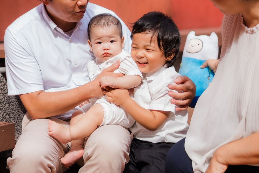 A series of candid family moments showing parents and children interacting together while wearing white clothing.