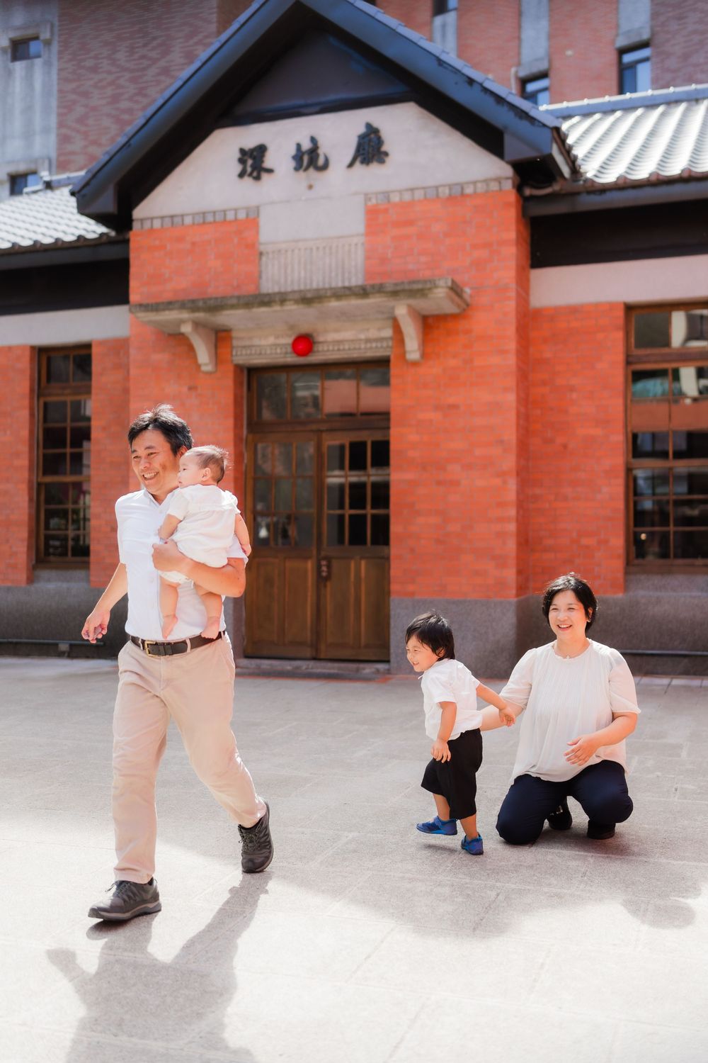 A series of playful interactions between family members in a brick courtyard setting.