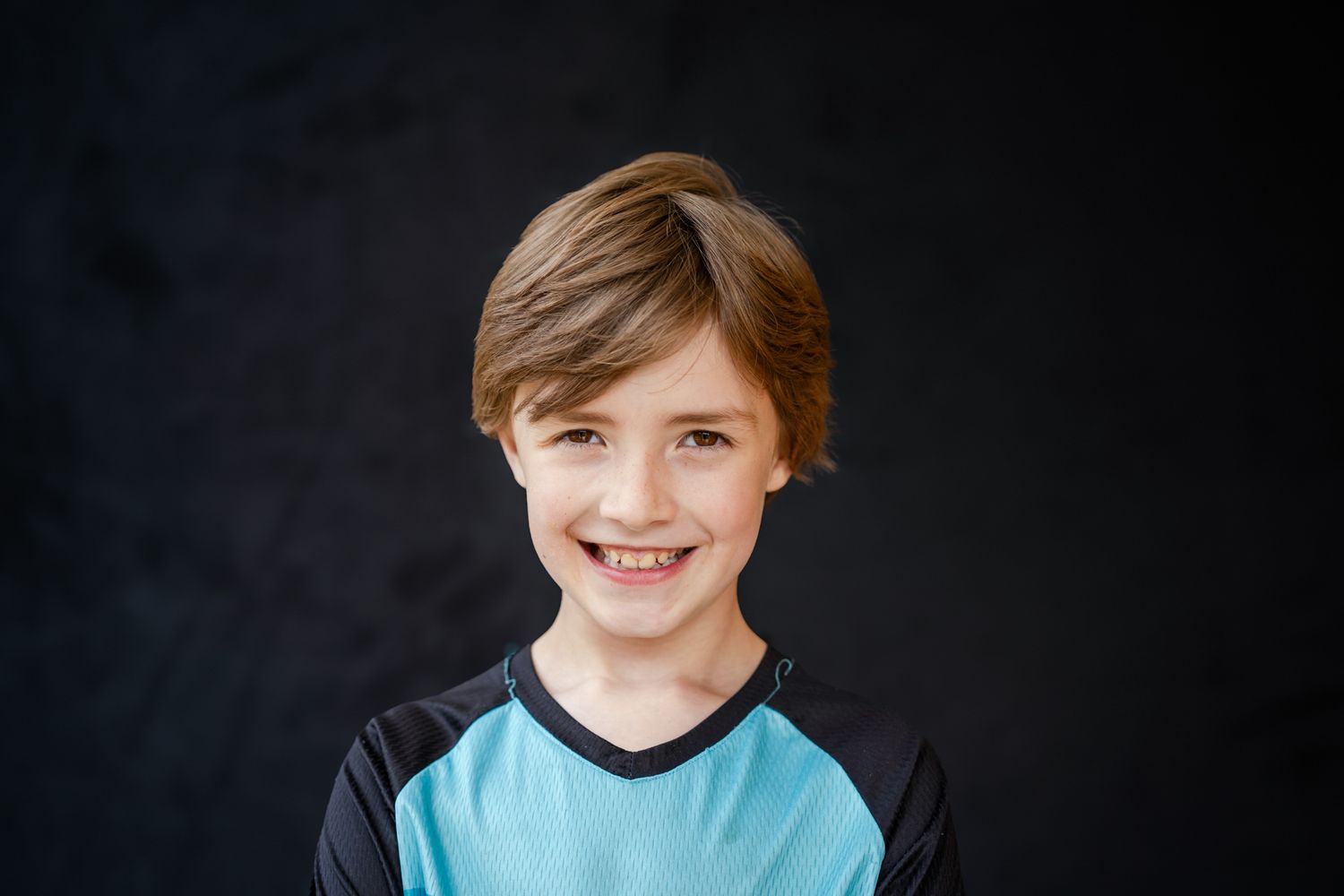 School portrait of a young boy in blue