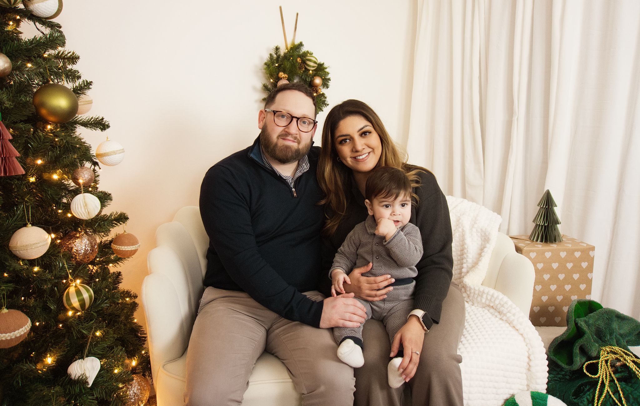 A family Christmas photo in a warm setting.