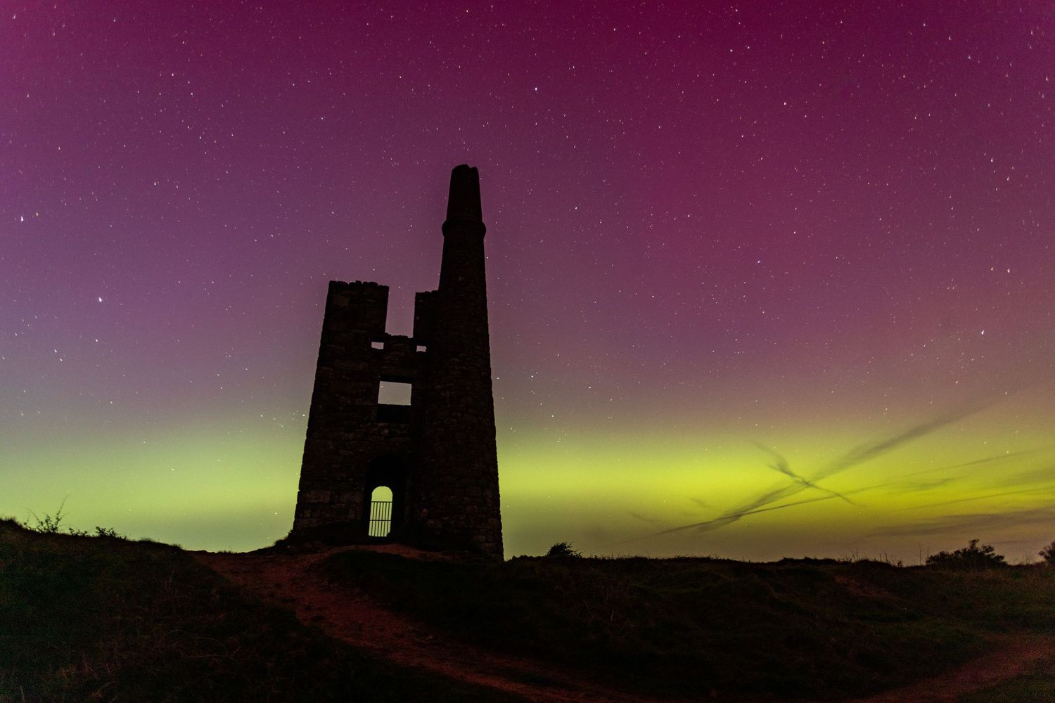 Aurora Borealis in Cornwall.  Cornish engine house silhouetted at night