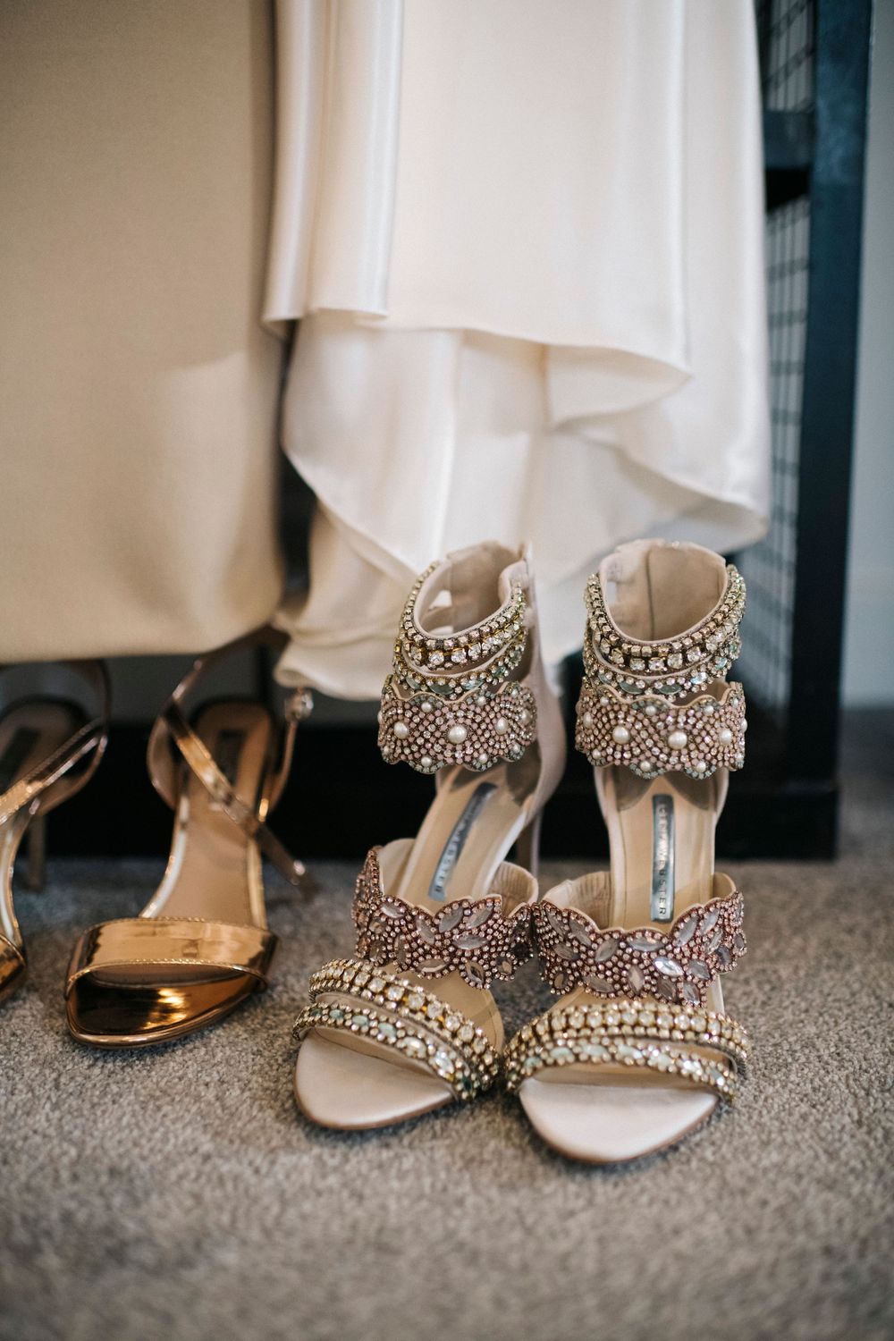 Elegant crystal-embellished bridal shoes lined up on display.