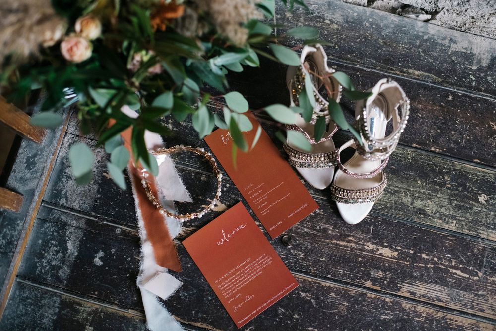 Wedding details including greenery and rustic wooden textures.