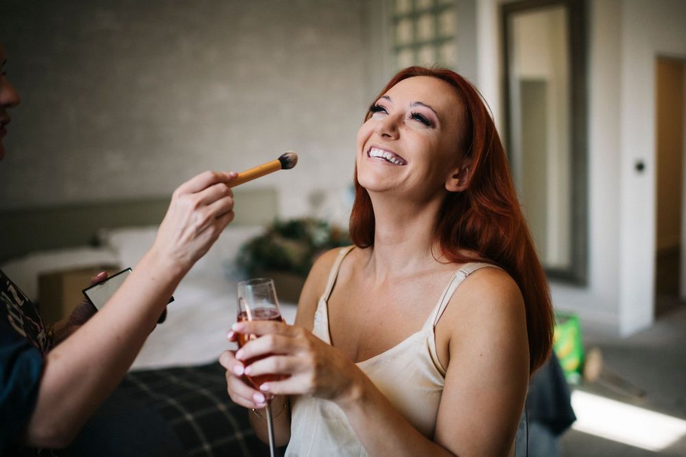 A candid moment of someone enjoying appetizers during wedding preparations.