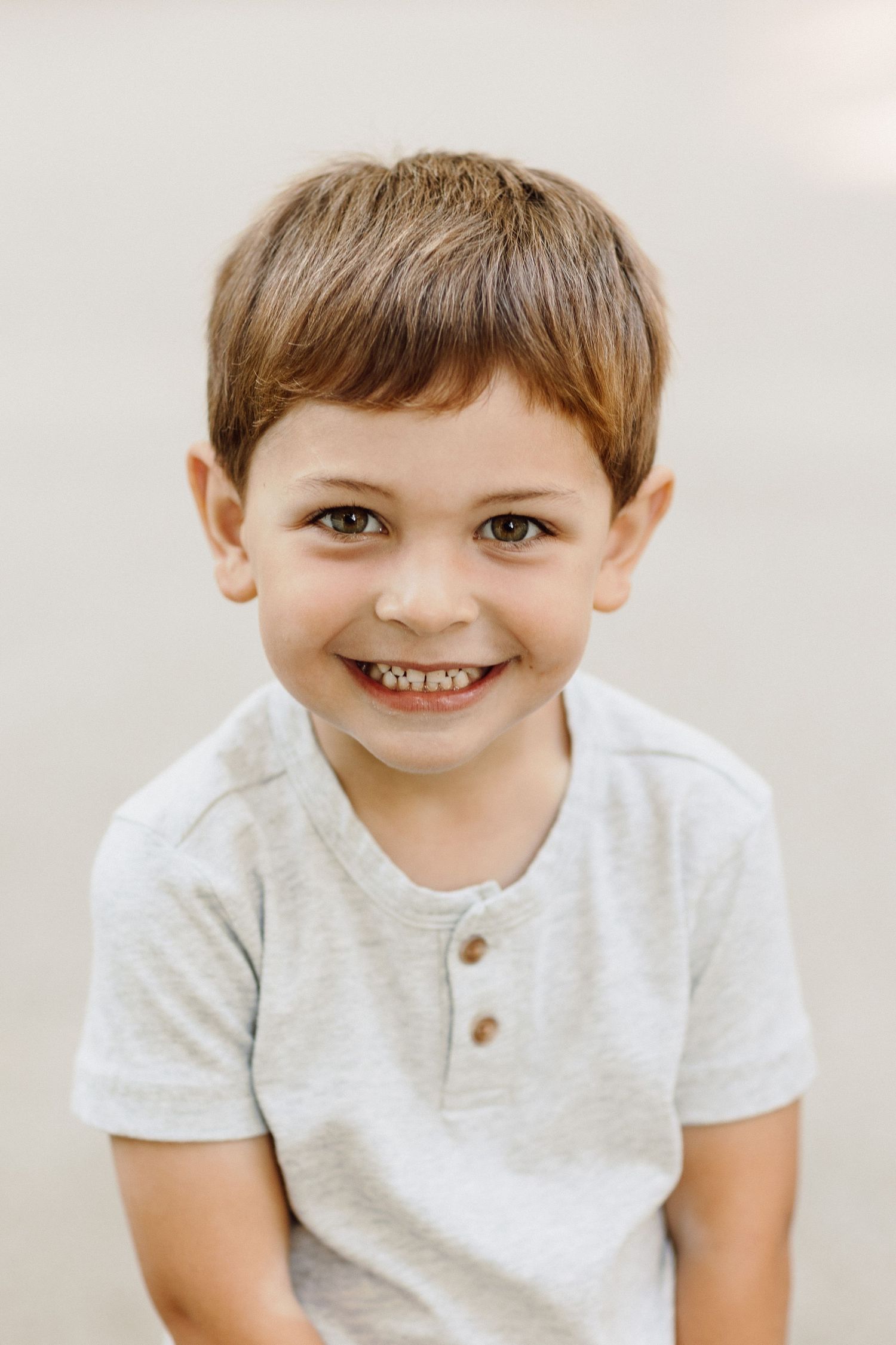 Close-up portrait series showing joyful expressions in white shirt.