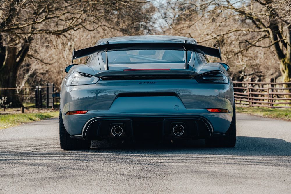 Rear view of Porsche GT4 RS showcasing aggressive diffuser and dual exhaust design.