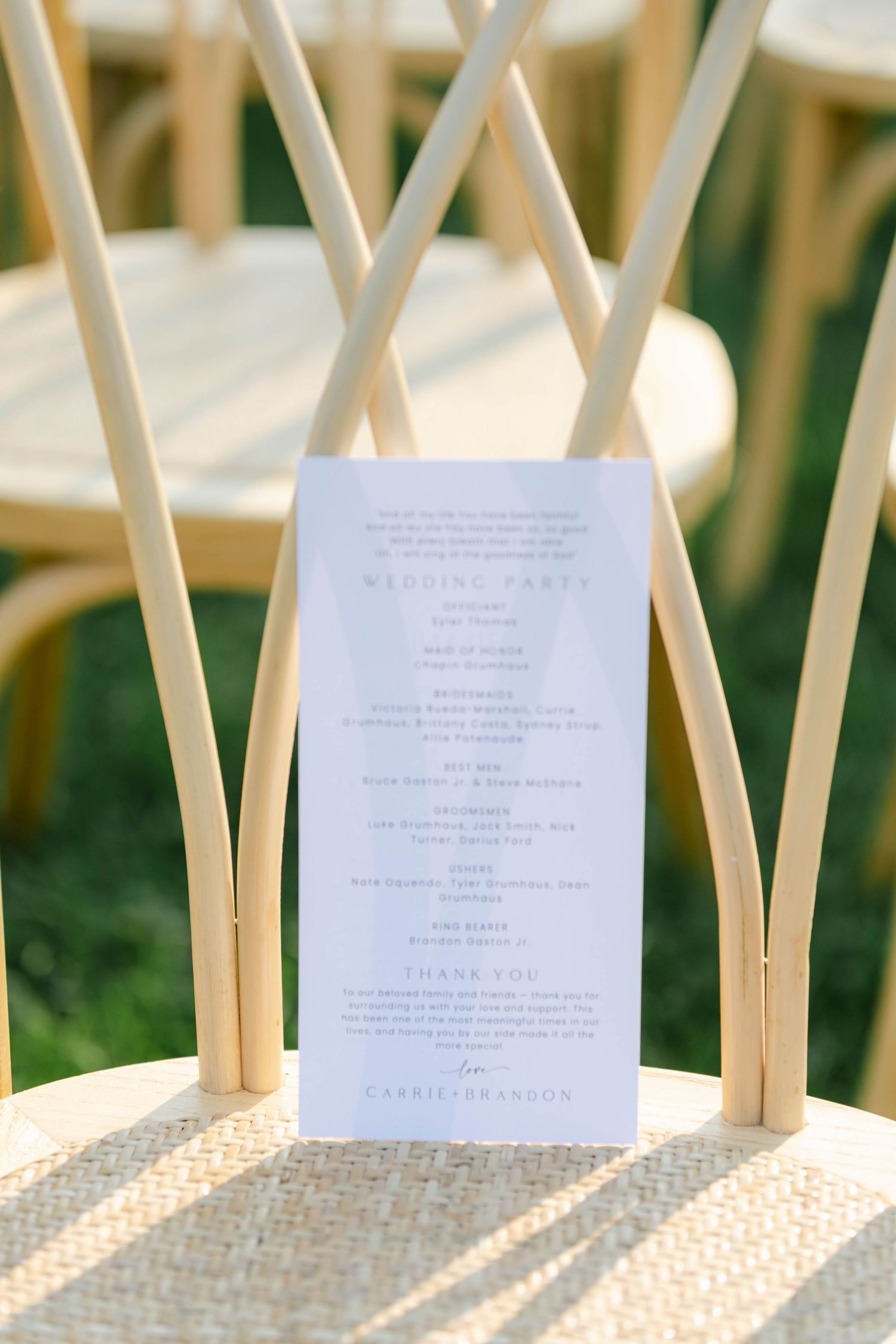White paper wedding menus displayed on wooden chairs casting geometric shadows in natural sunlight. - Elawa Farm