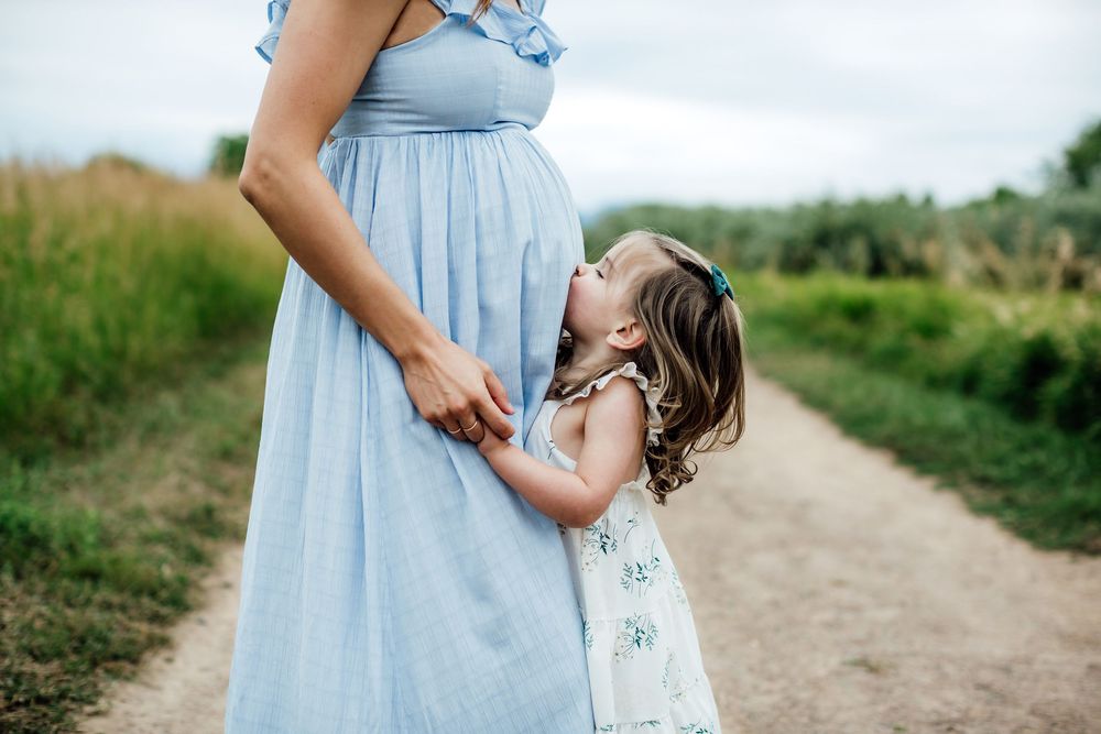 Light blue dress flowing in a gentle breeze against a natural outdoor backdrop.