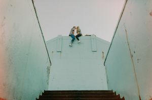 Empty staircase with turquoise walls leading upward in an architectural setting.