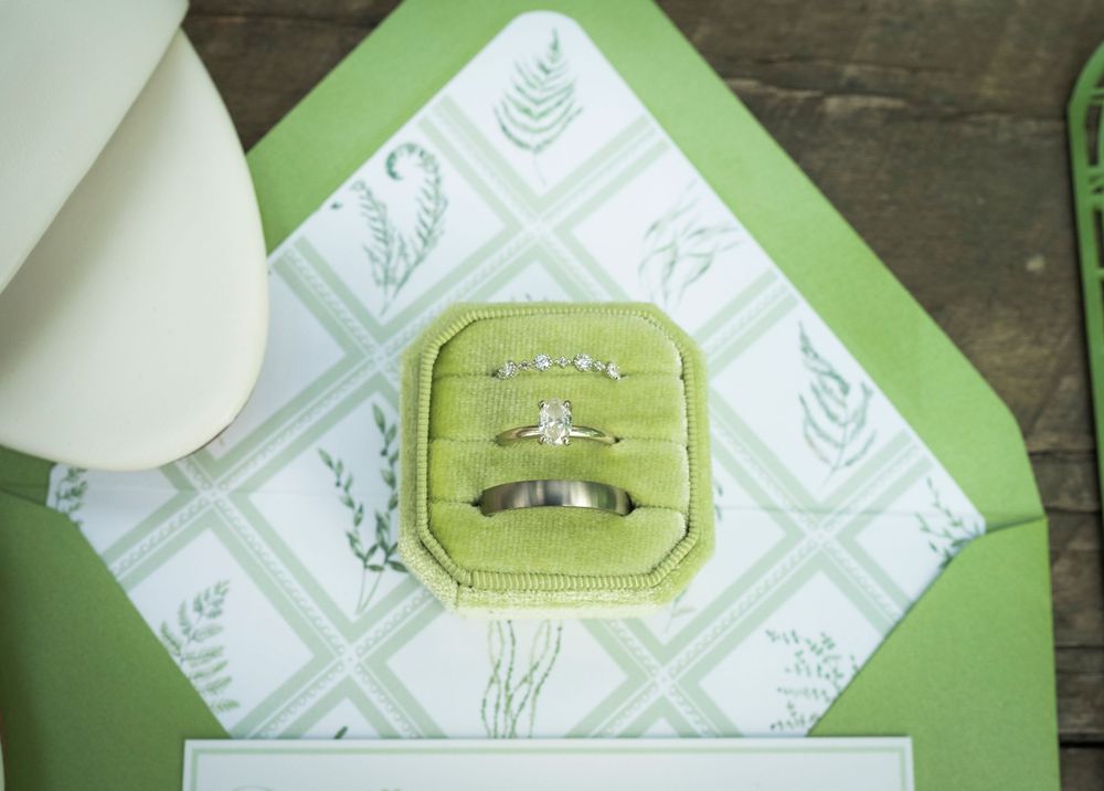 White paper napkins with a green geometric pattern arranged on a rustic wooden surface.
