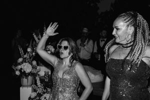 People dancing and celebrating at a lively nightclub party with flashing lights and energetic atmosphere.