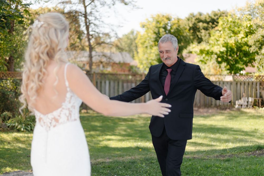 First look reaction sequence between bride and groom in outdoor garden setting during wedding day.