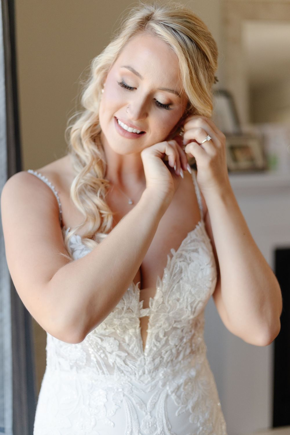 Close-up shots of a bride in a lace wedding dress laughing and showing genuine emotion.