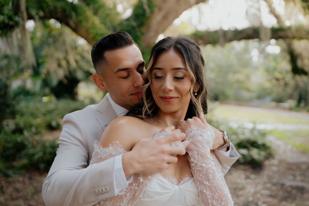A romantic wedding photoshoot featuring tender moments between a couple in a natural outdoor setting.