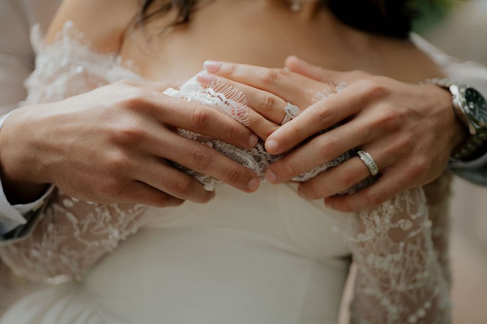Close-up shots of hands with wedding rings showing intricate lace sleeve details.