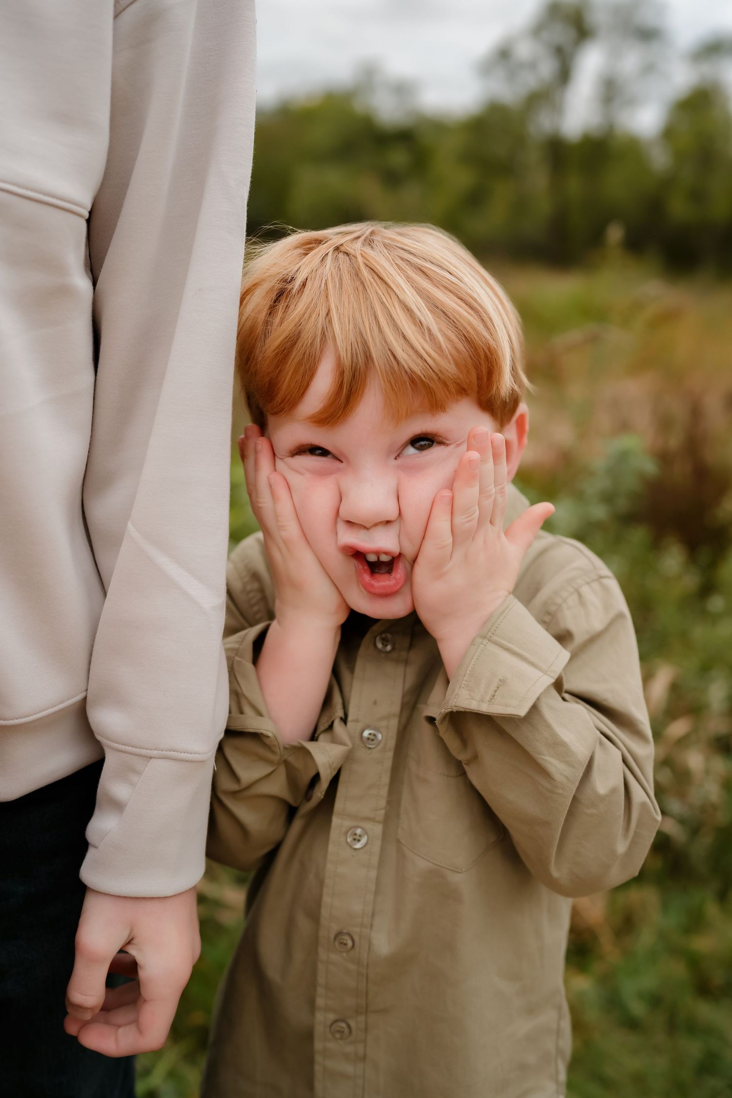 A sequence of photos capturing a child in a beige shirt making silly faces while standing outdoors.