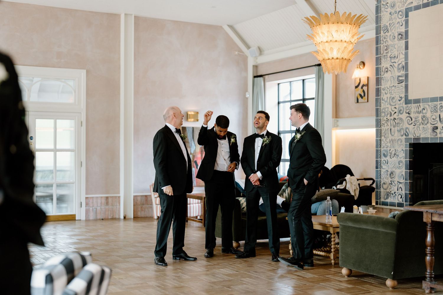 Wedding party members in formal attire gathered in an elegant reception venue.