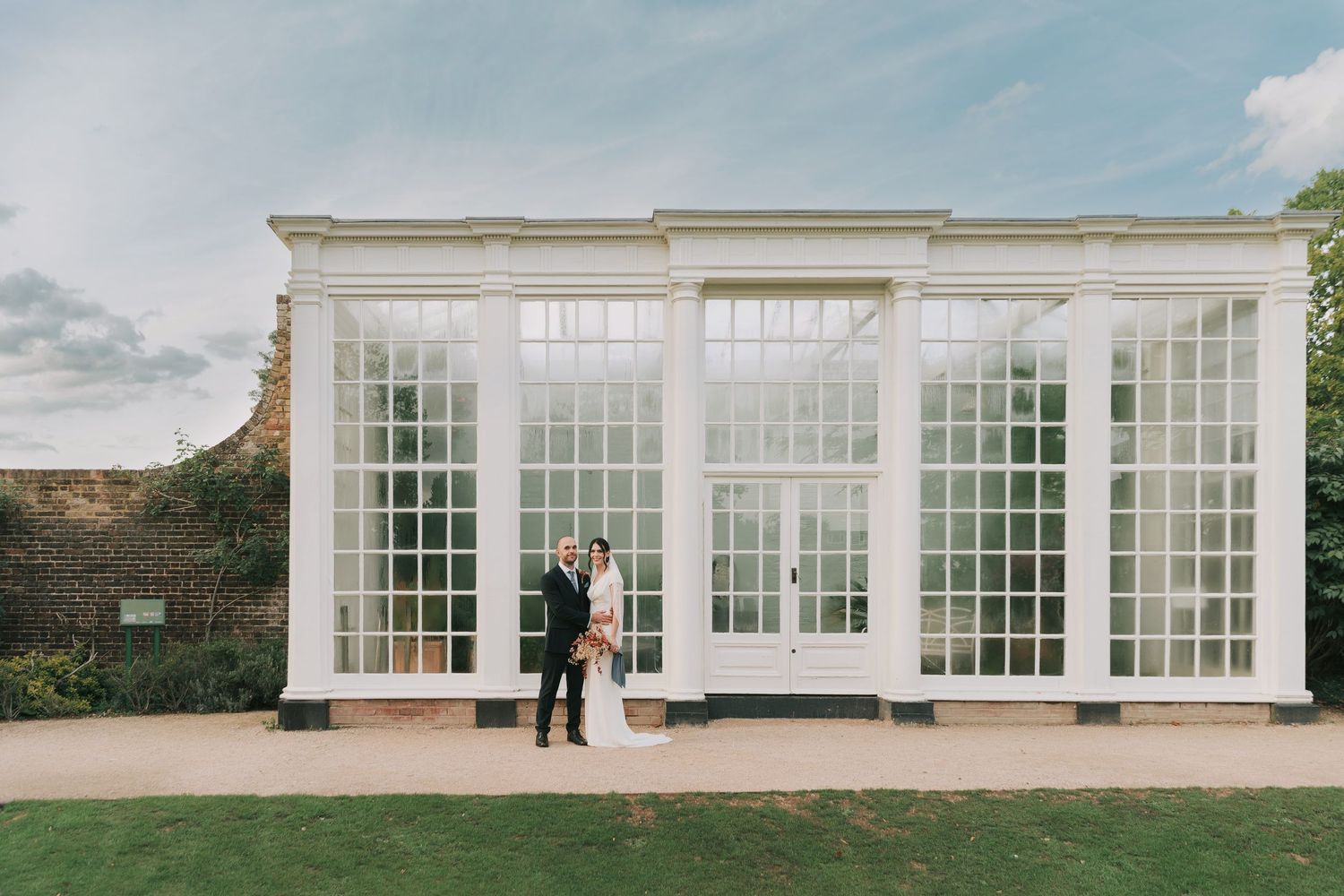 Modern white conservatory with large windows and glass panels creates an elegant architectural backdrop.