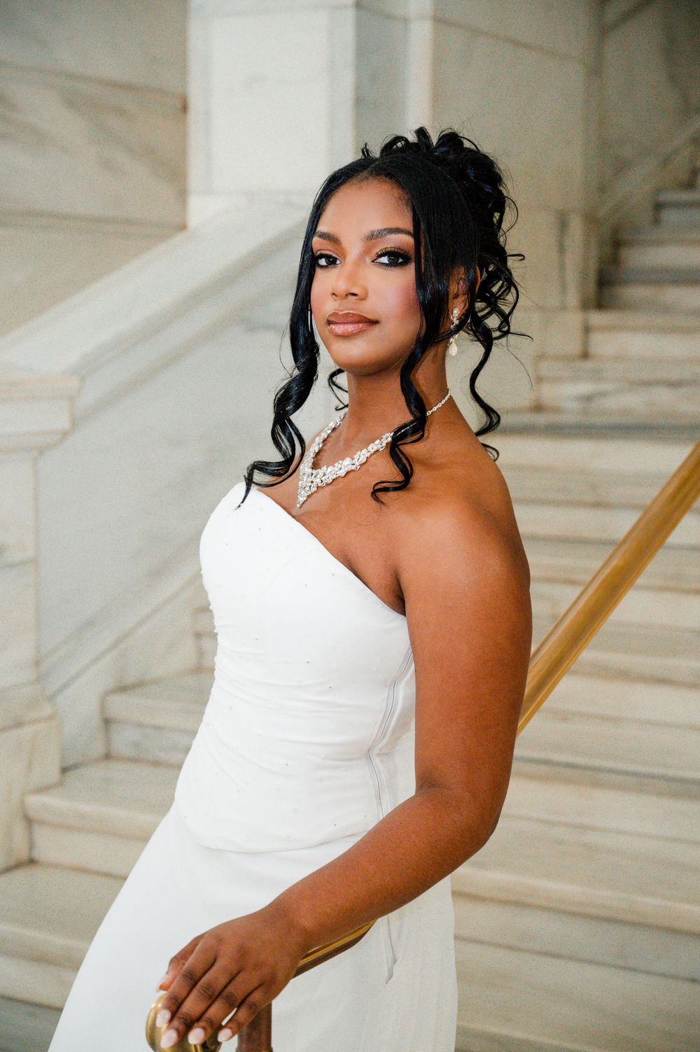 Wedding photography series showing different poses in a strapless white gown.