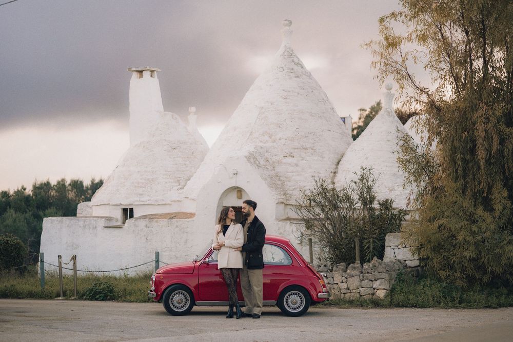 A series of romantic wedding photos showing a couple posing with a vintage red Fiat car in an outdoor setting.